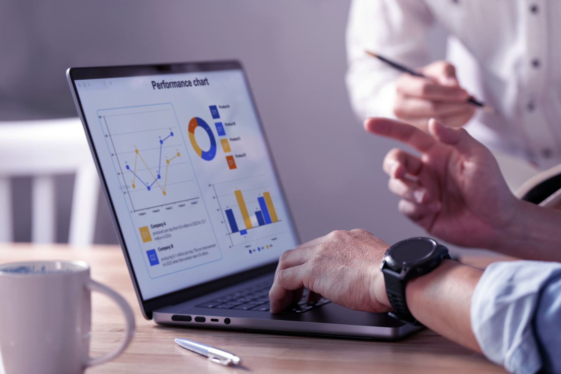 Built for growth Two people review a laptop displaying a Website Performance chart with graphs and data visualizations. One person points at the screen with a pen, analyzing insights from the SEO Dashboard built for growth.